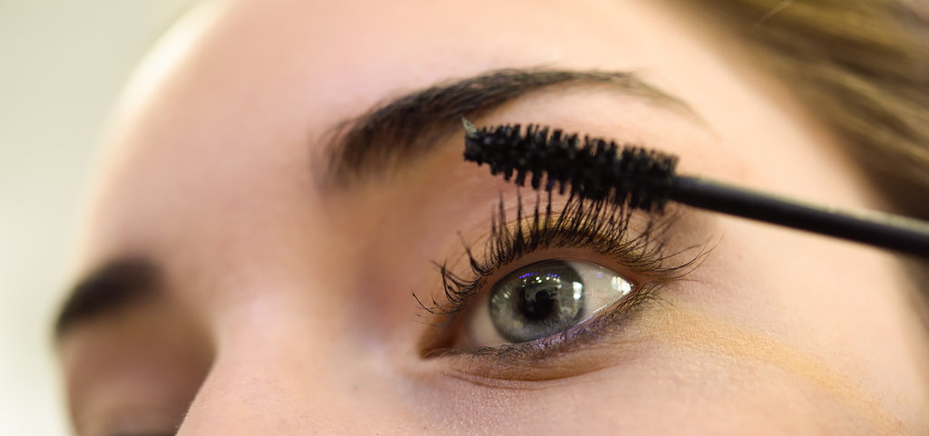 Make-up. Applying Mascara. Long Eyelashes and blue eyes