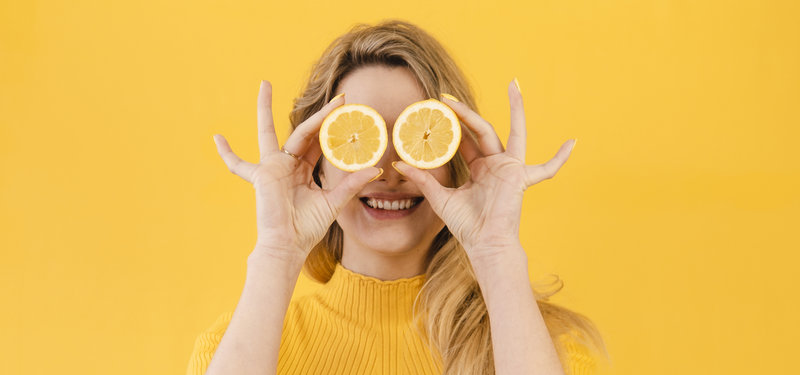women is holding lemons