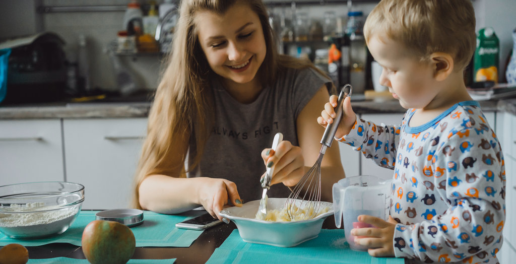 kid is baking with his mother