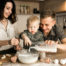 toddler and his parents baking in the kitchen