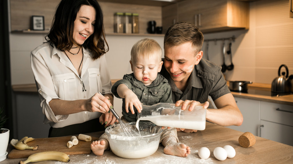 Family in the kitchen toddler and his parents baking in the kitchen