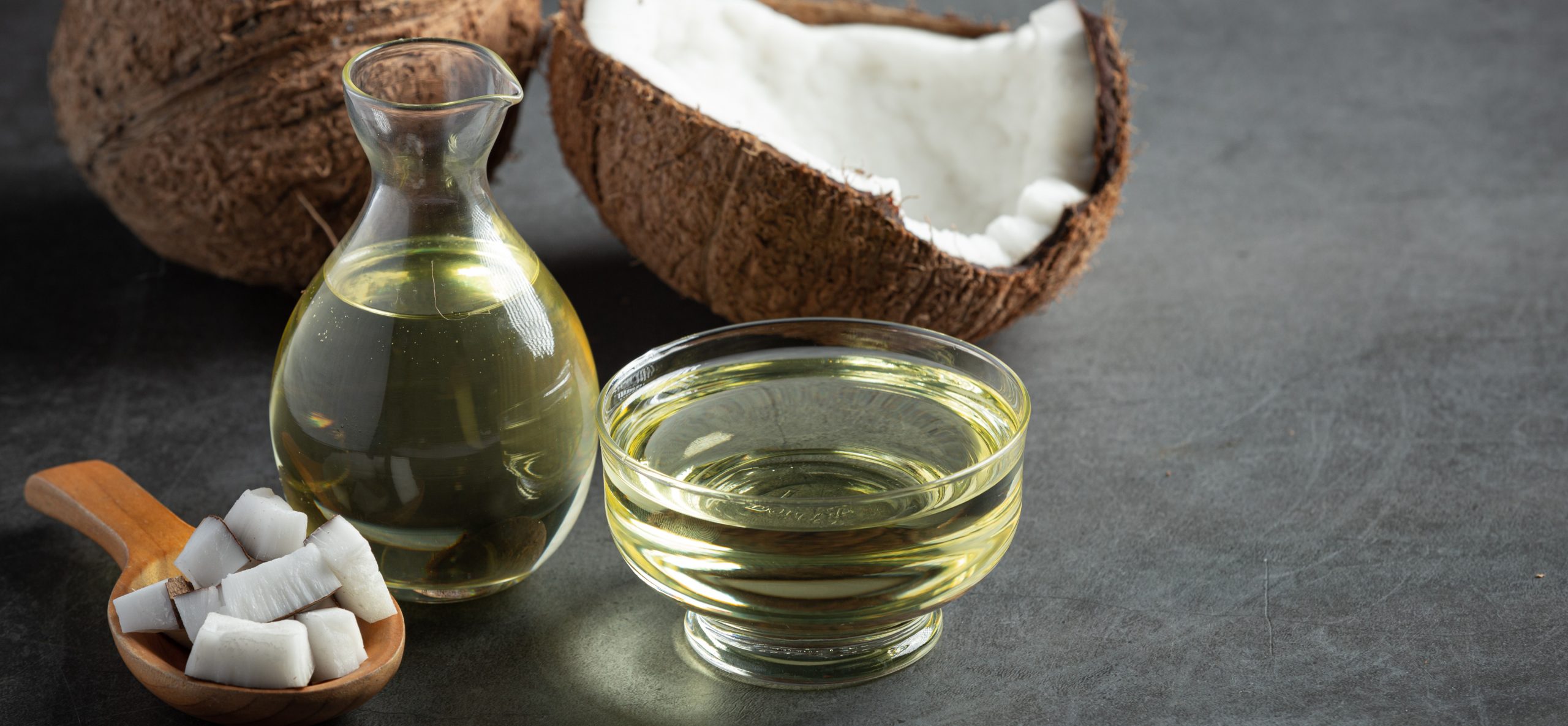 jug-coconut-oil-whit-coconut-put-dark-background (1) coconut oil