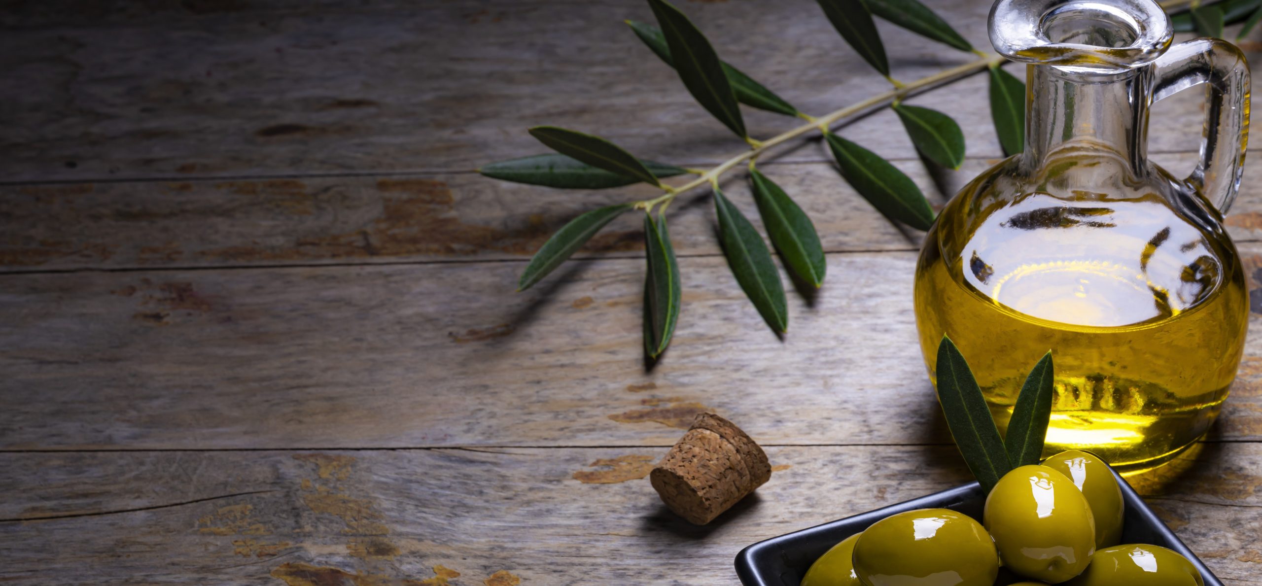 tasty-looking-olives-extra-virgin-olive-oil-olive-leafs-dark-wooden-background olive oil carrier oil