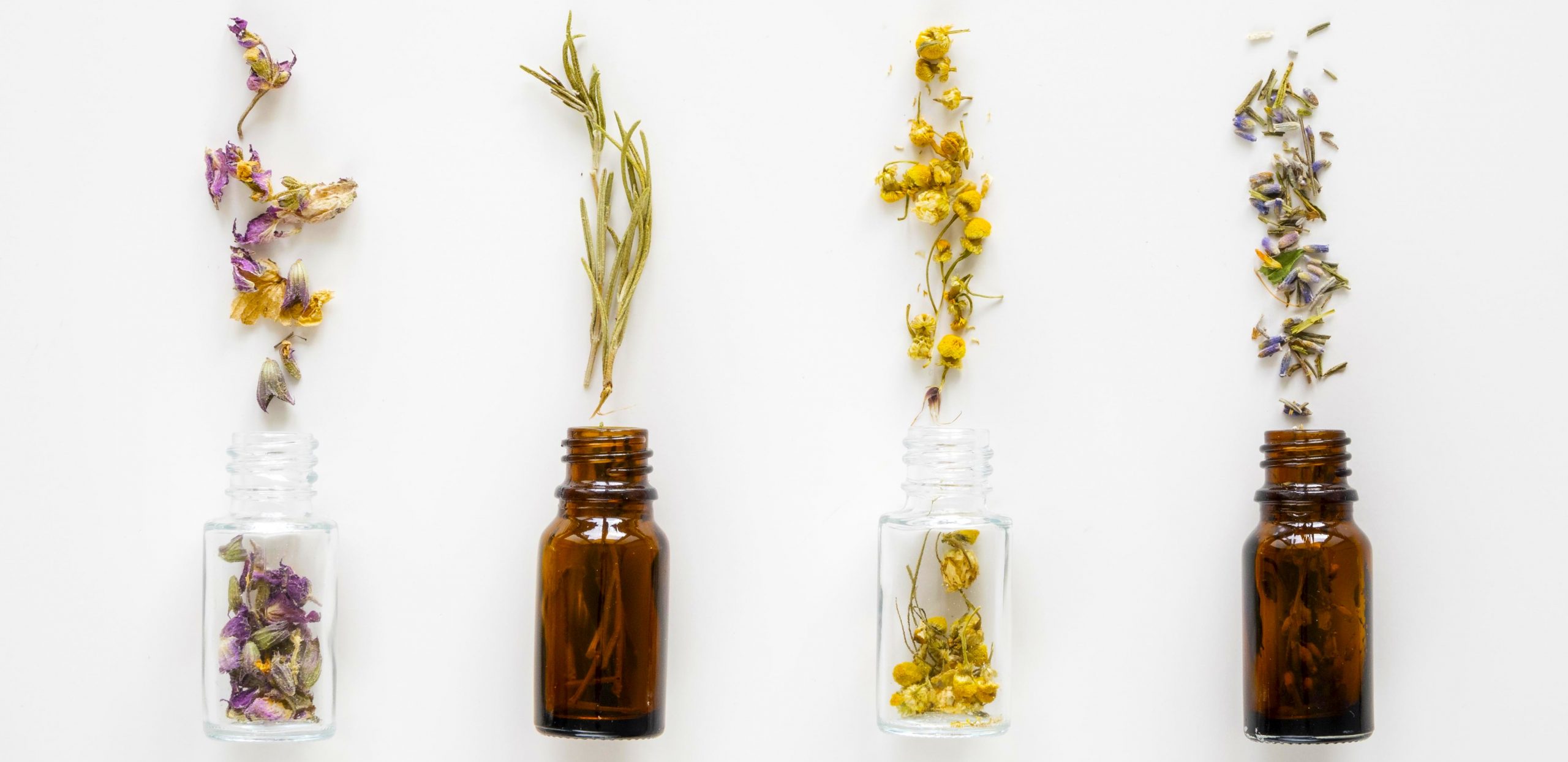 top-view-natural-medicinal-herbs-bottles essential oil guide for every skin concern